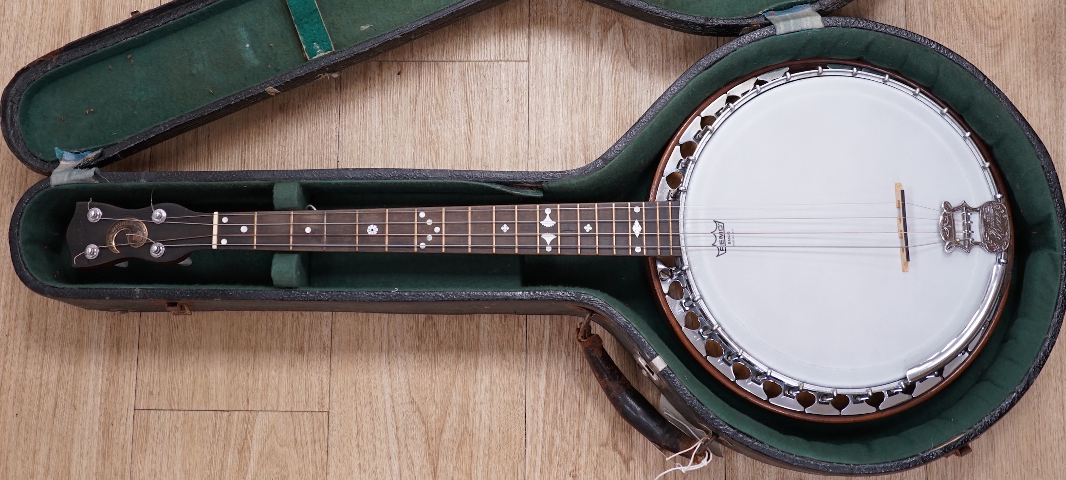 A cased English 1930s Windsor Whirl four string tenor banjo, mother of pearl inlaid neck, length of body 33cm, overall length 84cm, in fitted case